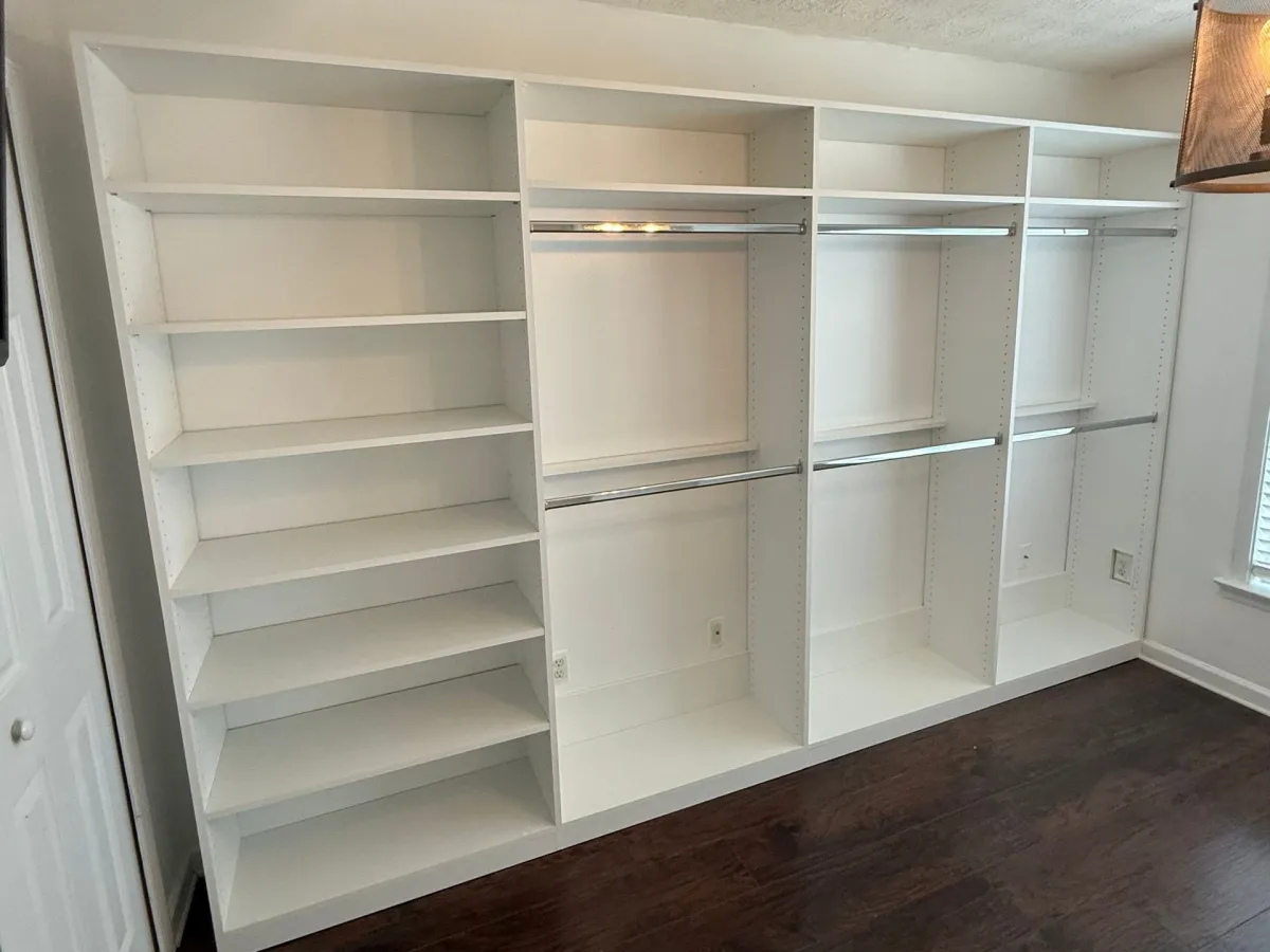 Custom white mudroom built-in with cubbies, hooks, and bench by Pi Cabinetry